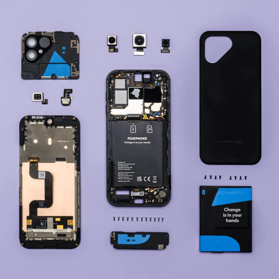 Disassembled Fairphone laid out on a purple background.